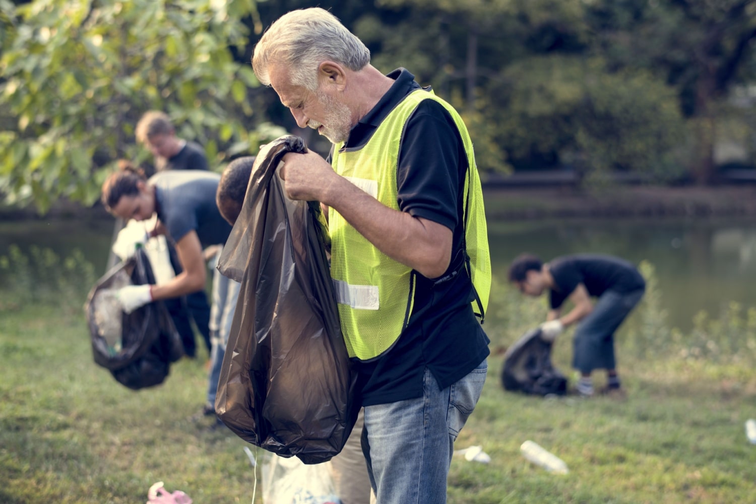 Menschen räumen Park auf, gemeinnützige Arbeit