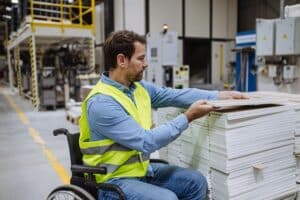 Rollstuhlfahrer arbeitet im Baumarkt